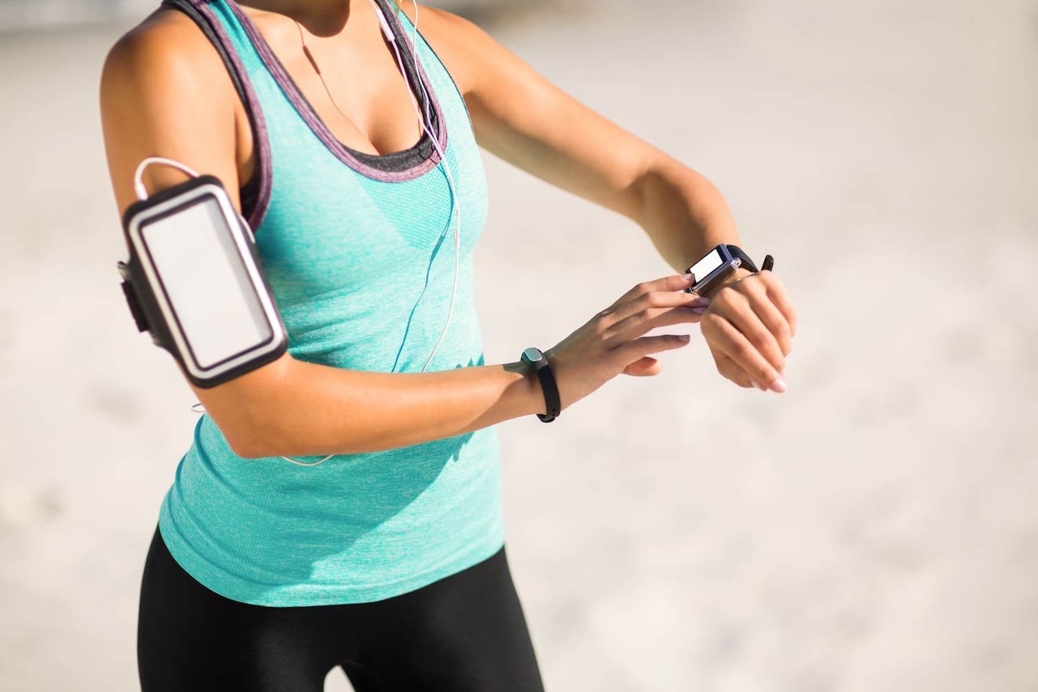 Woman using smart watch in running clothes