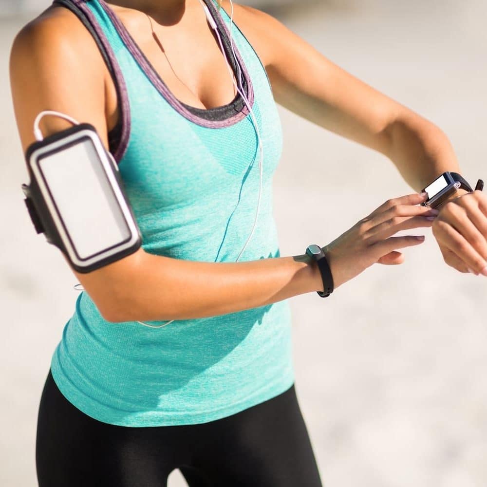 Woman using smart watch in running clothes